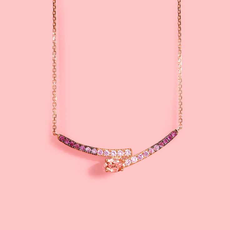 It features an elegant, asymmetric bypass bar pendant