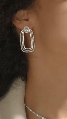 open-hoop style rectangular drops suspended from a square or cushion-cut stud.