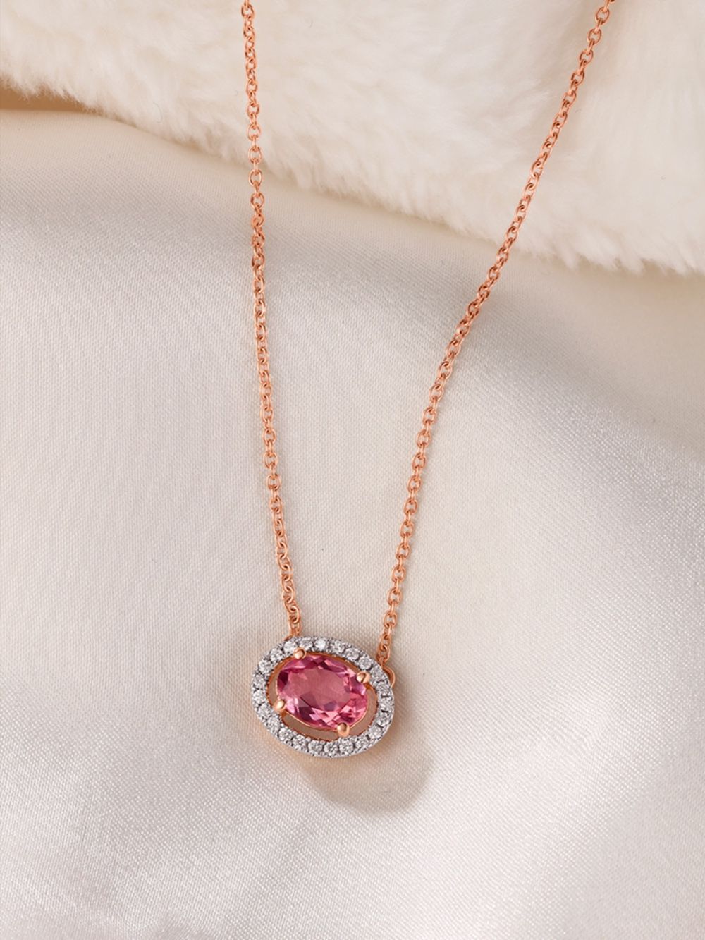 The centerpiece is an oval-cut pink gemstone